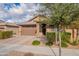 Attractive curb appeal with a two-car garage and nicely landscaped yard at 21667 S 225Th Way, Queen Creek, AZ 85142