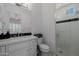 Modern bathroom featuring a walk-in shower with glass door, a stylish vanity with a large mirror and contemporary fixtures at 12651 S 71St St, Tempe, AZ 85287