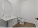 Bathroom boasts classic pedestal sink and matching toilet at 12651 S 71St St, Tempe, AZ 85287