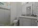 Bright bathroom featuring a glass-enclosed shower, modern vanity with lots of storage, and mosaic tile accents at 12651 S 71St St, Tempe, AZ 85287