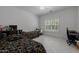 A well-lit bedroom with two beds, a window with plantation shutters, and a ceiling fan at 12651 S 71St St, Tempe, AZ 85287