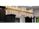 A modern chandelier with white glass and gold accents hangs in the kitchen at 12651 S 71St St, Tempe, AZ 85287