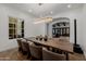 Dining room features long wooden table, seating for eight, wood floors, and a modern crystal light fixture at 12651 S 71St St, Tempe, AZ 85287