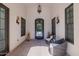 Inviting entry with decorative iron door and sconces, seating and natural light at 12651 S 71St St, Tempe, AZ 85287