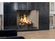 Close up of marble fireplace with lit fire at 12651 S 71St St, Tempe, AZ 85287
