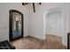 Grand foyer with wrought iron door, arched doorway and tiled floors at 12651 S 71St St, Tempe, AZ 85287