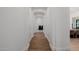 Bright hallway with wood flooring, arched doorways leading to dining area at 12651 S 71St St, Tempe, AZ 85287