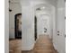 Bright hallway with wood flooring and arched doorways and a decorative metal door at 12651 S 71St St, Tempe, AZ 85287