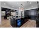 Modern kitchen with black cabinets, luxury appliances and view of the living room at 12651 S 71St St, Tempe, AZ 85287