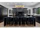 Stunning kitchen with black cabinets, gold hardware, marble countertops and modern lighting fixture over the island at 12651 S 71St St, Tempe, AZ 85287
