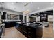 Spacious kitchen featuring a large island, black cabinets, and an open floor plan at 12651 S 71St St, Tempe, AZ 85287