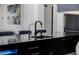 Close-up of the kitchen island with a modern faucet and seating at 12651 S 71St St, Tempe, AZ 85287