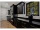 Modern kitchen featuring dark cabinetry, gold hardware, and sleek countertops at 12651 S 71St St, Tempe, AZ 85287
