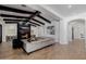 Elegant living room featuring a modern fireplace, comfortable seating, wood-look tile floors and beamed ceilings at 12651 S 71St St, Tempe, AZ 85287