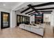 Open-concept living room with black ceiling beams, fireplace, and tile flooring at 12651 S 71St St, Tempe, AZ 85287