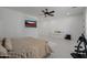 Bright main bedroom featuring a wall-mounted television and a large decorative dresser at 12651 S 71St St, Tempe, AZ 85287