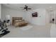 Spacious main bedroom featuring neutral decor, a ceiling fan, and a wall-mounted television for ultimate relaxation at 12651 S 71St St, Tempe, AZ 85287