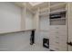 Well-organized walk-in closet featuring multiple shelves, drawers, and hanging rods for optimal storage solutions at 12651 S 71St St, Tempe, AZ 85287