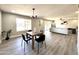 Light and airy dining room with a wood table and four chairs at 18442 N 104Th Ave, Sun City, AZ 85373