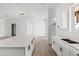 Modern kitchen with white cabinets, quartz counters, and island at 22750 E Roper Ln, Florence, AZ 85132