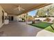 Covered patio, putting green, and landscaped backyard at 25809 S Hollygreen Dr, Sun Lakes, AZ 85248