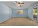 Bedroom with light blue walls, ceiling fan, and sliding glass door at 25809 S Hollygreen Dr, Sun Lakes, AZ 85248