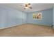 Light blue bedroom with carpet, ceiling fan and sliding glass door at 25809 S Hollygreen Dr, Sun Lakes, AZ 85248