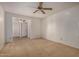 Bright bedroom featuring ceiling fan and neutral carpeting at 25809 S Hollygreen Dr, Sun Lakes, AZ 85248