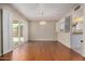 Dining area with hardwood floors, chandelier, and sliding glass doors at 25809 S Hollygreen Dr, Sun Lakes, AZ 85248