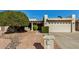 Front view of a single-story home with a two-car garage and well-manicured landscaping at 25809 S Hollygreen Dr, Sun Lakes, AZ 85248