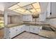 Kitchen with granite countertops, white cabinets, and a ceiling fan at 25809 S Hollygreen Dr, Sun Lakes, AZ 85248