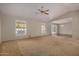 Spacious living room featuring vaulted ceilings, carpeting, and large windows at 25809 S Hollygreen Dr, Sun Lakes, AZ 85248