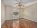 Living room with hardwood floors and arched window with shutters at 25809 S Hollygreen Dr, Sun Lakes, AZ 85248