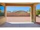 Covered back patio with brick pavers and views of the neighboring houses at 19591 W Lincoln St, Buckeye, AZ 85326