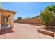 A spacious backyard featuring red brick pavers and a partial block wall at 19591 W Lincoln St, Buckeye, AZ 85326