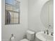 Powder bathroom with a white sink, toilet and modern finishes at 19591 W Lincoln St, Buckeye, AZ 85326