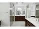 Spacious bathroom featuring a glass shower, vanity with dark wood cabinets, and tile floors at 19591 W Lincoln St, Buckeye, AZ 85326