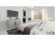 Bright bedroom featuring large TV, neutral walls, stylish furniture and abundant natural light at 19591 W Lincoln St, Buckeye, AZ 85326