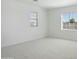 Empty room featuring carpeting and two windows providing ample natural light at 19591 W Lincoln St, Buckeye, AZ 85326