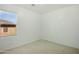 Empty bedroom with a window overlooking the exterior of the home at 19591 W Lincoln St, Buckeye, AZ 85326