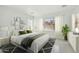 Stylish bedroom with a large window, neutral tones, elegant furniture, and ample space at 19591 W Lincoln St, Buckeye, AZ 85326