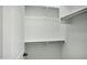 Walk-in closet with white walls and shelving for storage space at 19591 W Lincoln St, Buckeye, AZ 85326