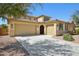 Stunning home showcasing a three-car garage, desert landscaping, and a tile roof at 19591 W Lincoln St, Buckeye, AZ 85326