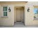 Inviting front entrance with decorative sconces and an arched entryway at 19591 W Lincoln St, Buckeye, AZ 85326
