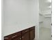 Hallway featuring countertops and cabinets with a doorway leading to a walk-in closet at 19591 W Lincoln St, Buckeye, AZ 85326