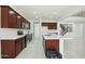 Spacious kitchen with white countertops, dark cabinets, stainless appliances and tile floors at 19591 W Lincoln St, Buckeye, AZ 85326