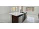 Bright kitchen features a large island with a sink, stainless steel appliances, and tile flooring at 19591 W Lincoln St, Buckeye, AZ 85326