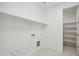 Bright laundry room with shelving, white walls and ample storage space at 19591 W Lincoln St, Buckeye, AZ 85326