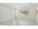 Bright living room featuring tile flooring, large windows, and abundant natural light at 19591 W Lincoln St, Buckeye, AZ 85326