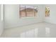 Bright living room featuring tile flooring, large windows, and abundant natural light at 19591 W Lincoln St, Buckeye, AZ 85326